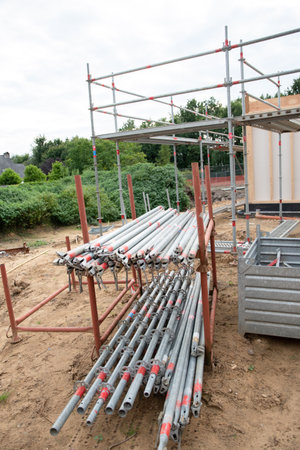 strong metal scaffolding at the construction site of a new house, the beginning