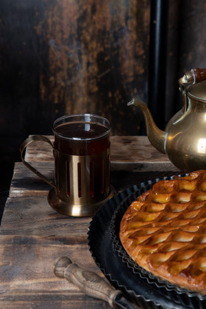 apricot pie with black tea on wooden table seasonal autumn still lifeの写真素材