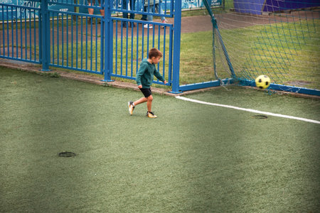 Genk, BELGIUM, August 18,2021:football player boy scores a goal in football,blurのeditorial素材