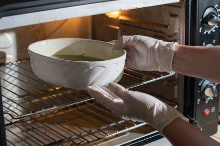 woman baked spinach muffin step by step,puts the form with the dough in the ovenの写真素材