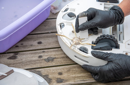 a woman cuts tangled hair with a knife on a brush with three side processesの写真素材