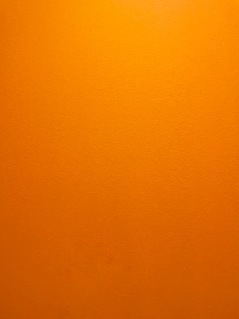 orange colored background, bright abstract texture of painted cement wallの写真素材
