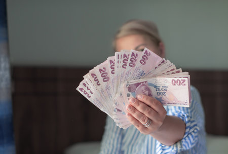 a large fan of 200 Turkish lira in the hands of a tourist in Turkey, a lot of money for shopping,...