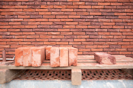 the beginning of brickwork with red bricks, building materials, a pattern of stones, a natural background. High quality photoの写真素材