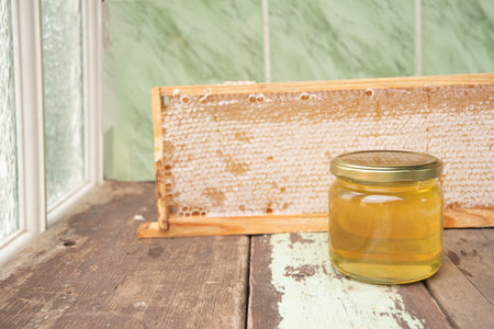 full honeycomb and jar of honey, organic fortified beekeeping product for healthy eating, alternative medicine, high quality photoの写真素材