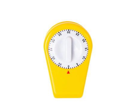 Yellow kitchen timer in the form of a clothespin, for precise keeping of cooking time, isolated on a white background, a simple but effective tool for time management in the kitchen,の写真素材