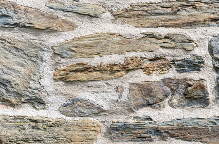Close up view of an old stone wall highlighting traditional construction methods, showcasing...