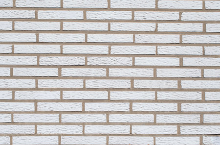 White brick background, textured surface showing spoon masonry, ideal for various design and...