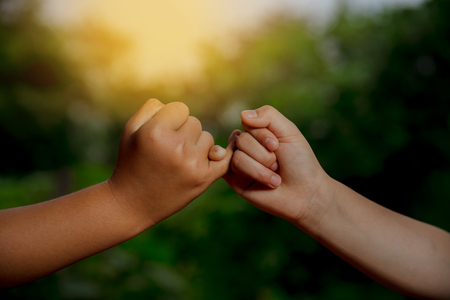 Two hands hook each other's little finger concept of promiseの写真素材