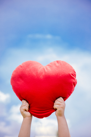 Red Hart in hand with sky bule, Red hart, Valentine Hart Simbolの写真素材