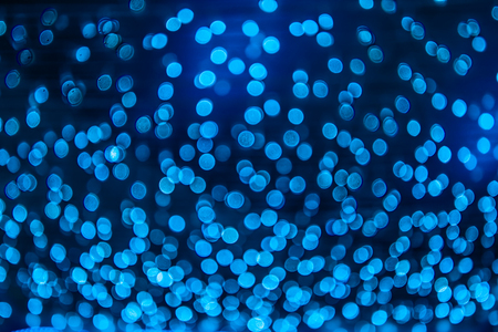 Abstract blue bokeh texture on black backgroundの写真素材