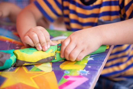Child playing with colorful clay making animal figures - closeup on handsの写真素材