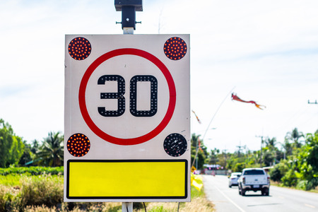 Round speed limit road sign on the road. 30 km per hourの写真素材