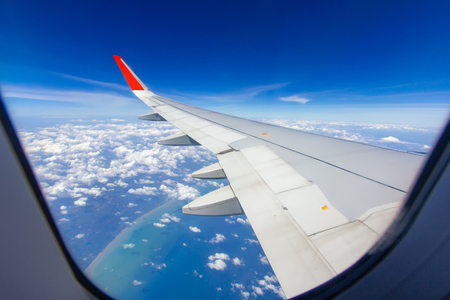 Sky wings and white clouds flying over Phuket, Thailandの写真素材