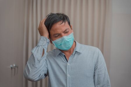 Male businessman who closes the protective mask Due to illness and coughの写真素材