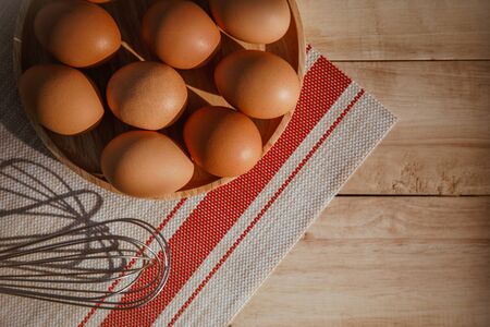 eggs in a wooden bowl. close up, top view, horizontalの写真素材