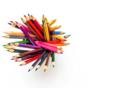 Colour pencils on white background close up