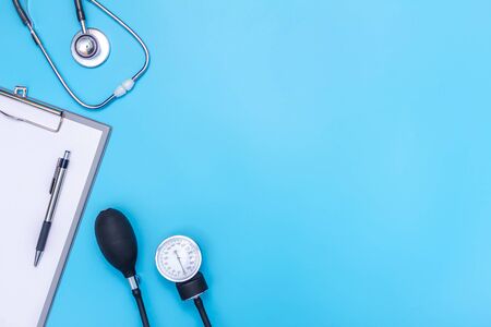 stethoscope and clipboard isolated on blue backgroundの写真素材