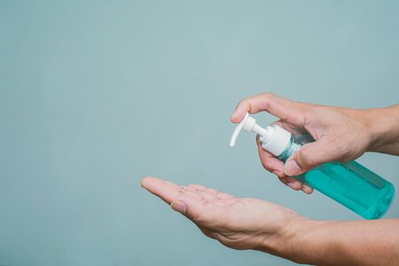 The hand is squeezing alcohol and there is space.の写真素材