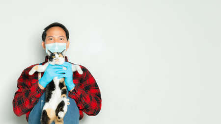 Pet owner affectionately holds a cat of 3 colors.