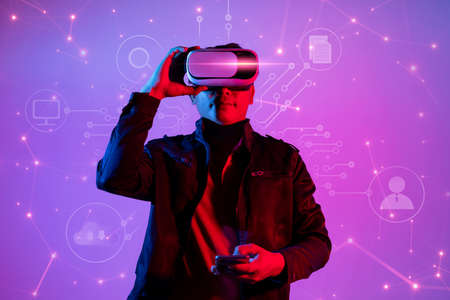 Metaverse digital cyber world technology, man with virtual reality VR goggle playing AR augmented...
