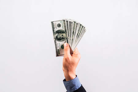 Businessman in suit holding several 100 dollar bills. Finance concept.の写真素材