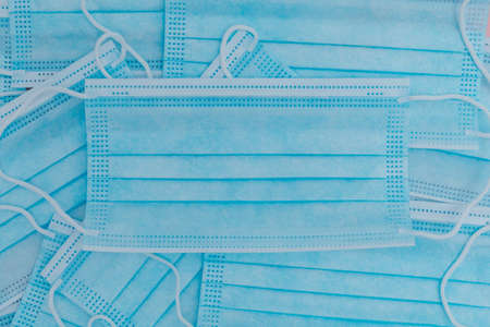 Lots of blue masks stacked on top of each other.の写真素材