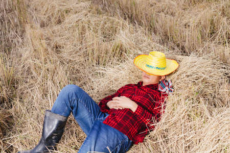 Asian farmer with rice stubble in the field