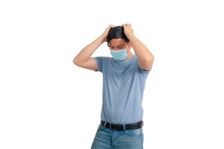 Asian man in blue t-shirt and medical mask isolated on white background.