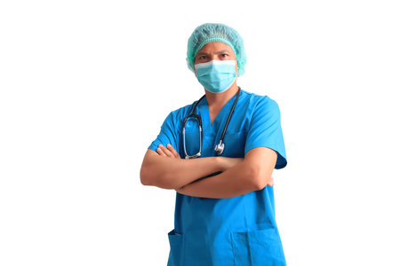 Asian male doctor wearing blue scrubs standing with arms crossed isolated on white backgroundの写真素材