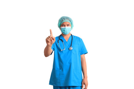 Asian male doctor wearing blue scrubs and mask isolated on white background.の写真素材