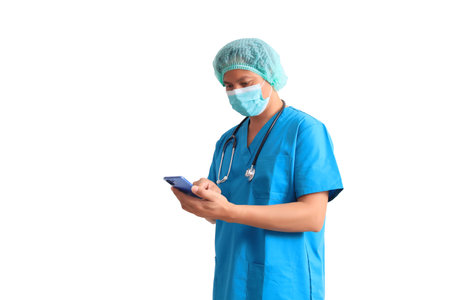 Portrait of Asian male doctor wearing surgical mask and holding mobile phone isolated on white background.の写真素材