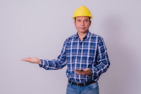 Asian engineer in striped shirt on white backgroundの写真素材