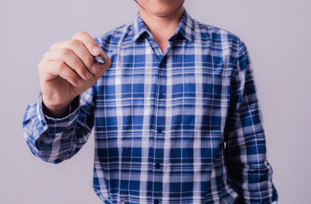 Asian engineer in striped shirt on white backgroundの写真素材