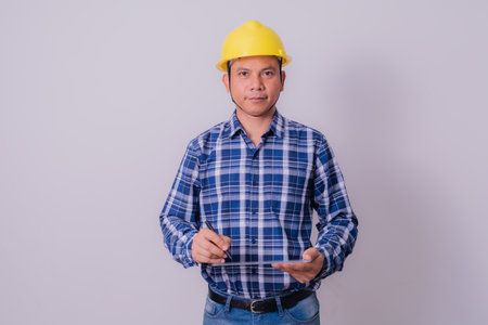Asian engineer in striped shirt on white backgroundの写真素材