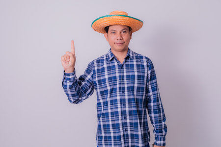 Asian farmer wearing striped shirtの写真素材