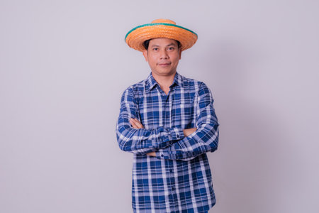 Asian farmer wearing striped shirtの写真素材