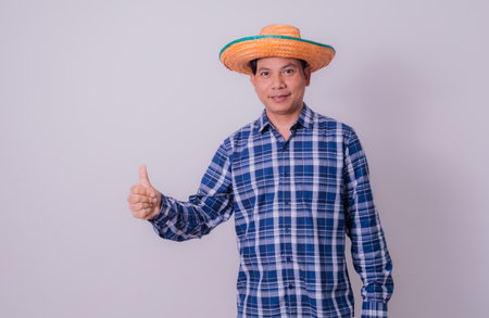 Asian farmer wearing striped shirtの写真素材