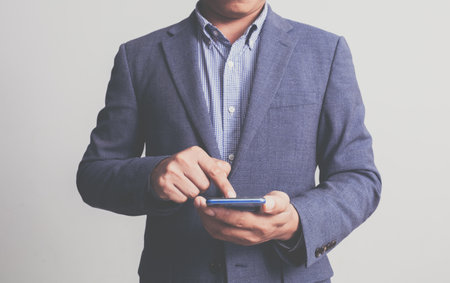 Businessman wearing a suit on a white backgroundの写真素材