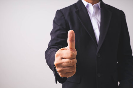 Business man showing thumb up on white background, Business success concept.の写真素材