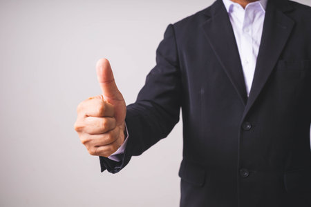Businessman offering hand for handshake, close-up on white backgroundの写真素材
