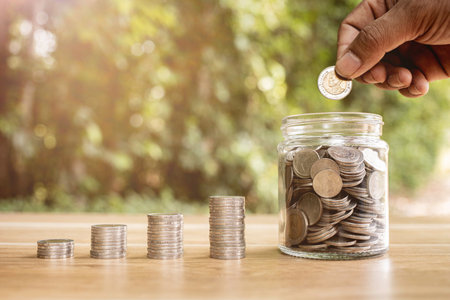 Coins in a clear glass jar money saving conceptの写真素材