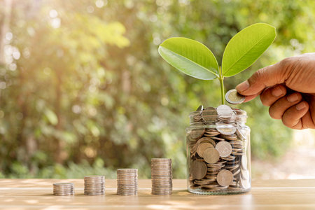 Coins in a clear glass jar money saving conceptの写真素材