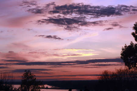Sunset with purple and pink hues in the skyの写真素材