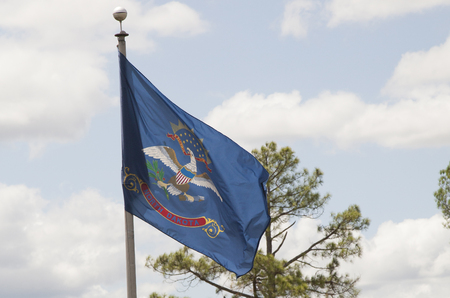 North Dakota state flag waving against blue skyの写真素材