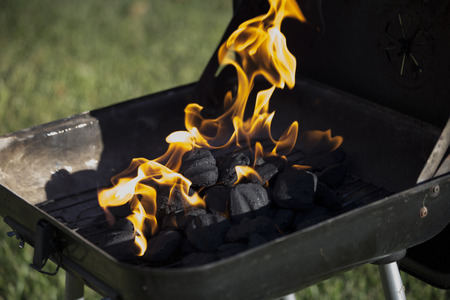 Flaming charcoal in barbecue pitの写真素材