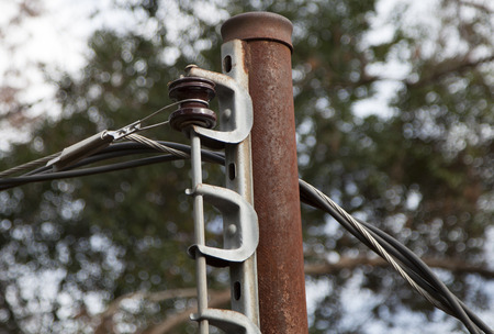 Rusted, old electric poleの写真素材
