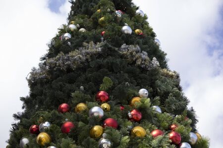 Outdoors Christmas tree with multicolored decorationsの写真素材