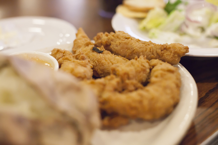 Chicken strips piled high on a plateの写真素材