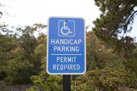 Close up of a blue accessible handicap parking signの写真素材